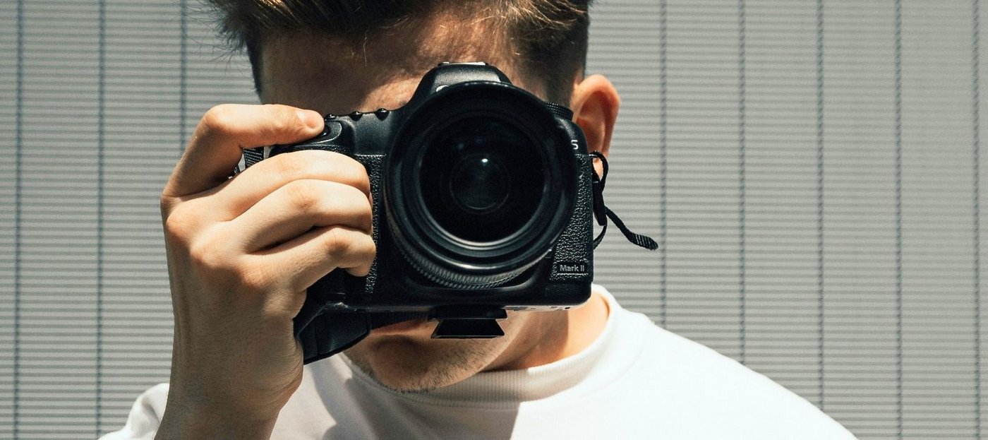 Junger Mann mit Kamera. Foto: Unsplash